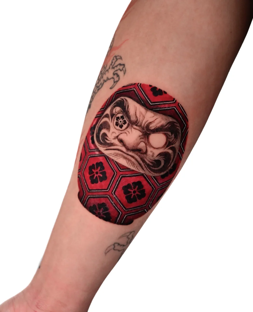 Red daruma doll with a patterned body, in colour