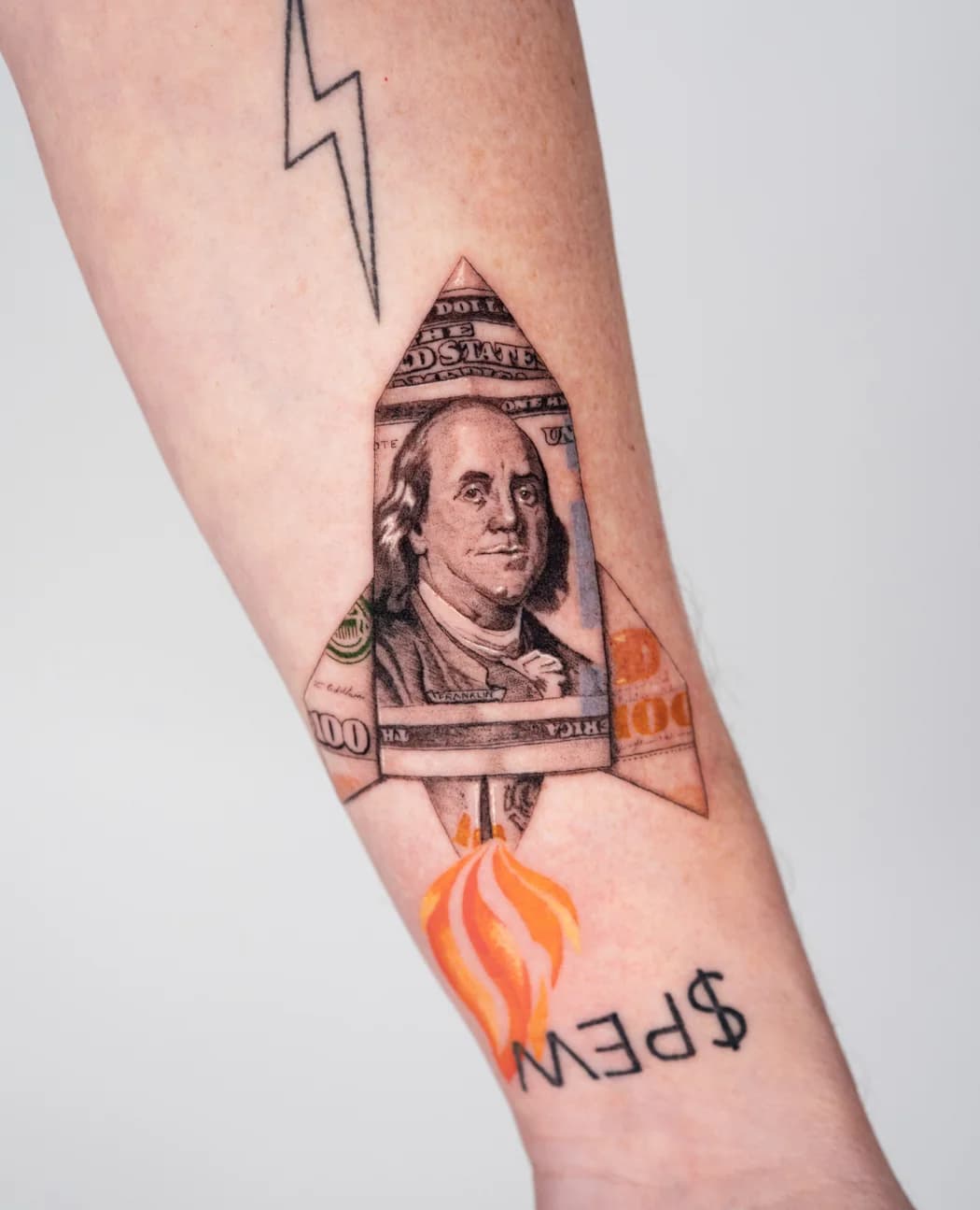 Dollar bill folded into a rocket, in colour