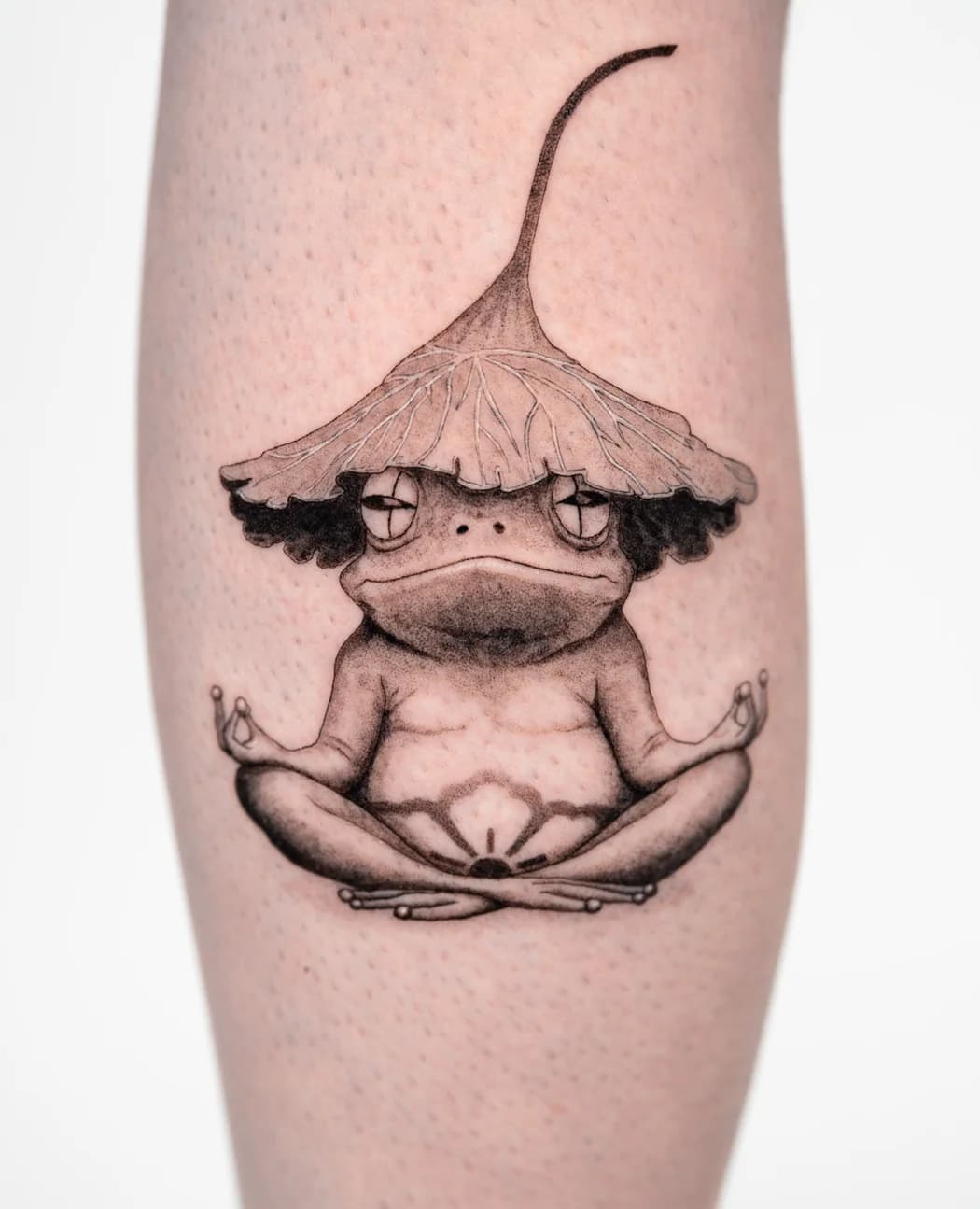 Frog meditating cross-legged under a mushroom cap
