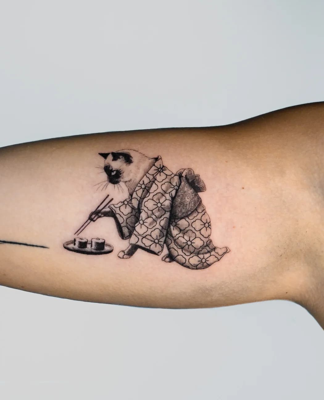 Robed figure kneeling over a tea set, fine line on an inner arm