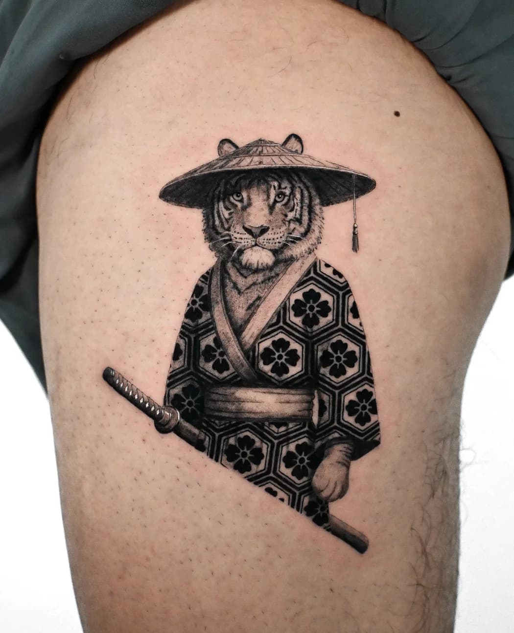 Tiger in a samurai kimono and straw hat, holding a katana, on a thigh