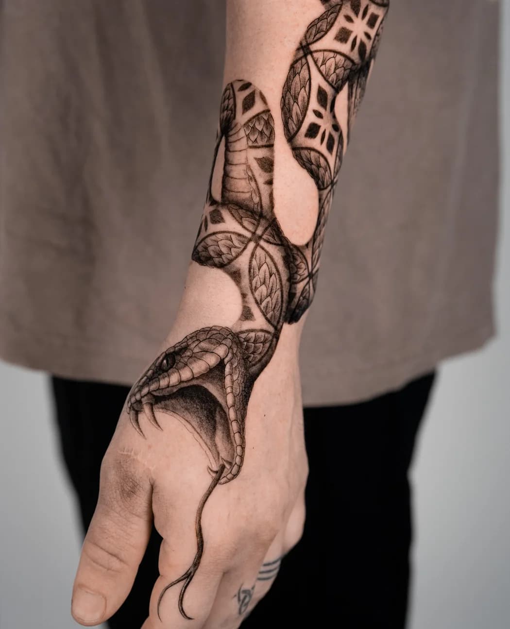 The same ornamental snake, seen from the back of the hand