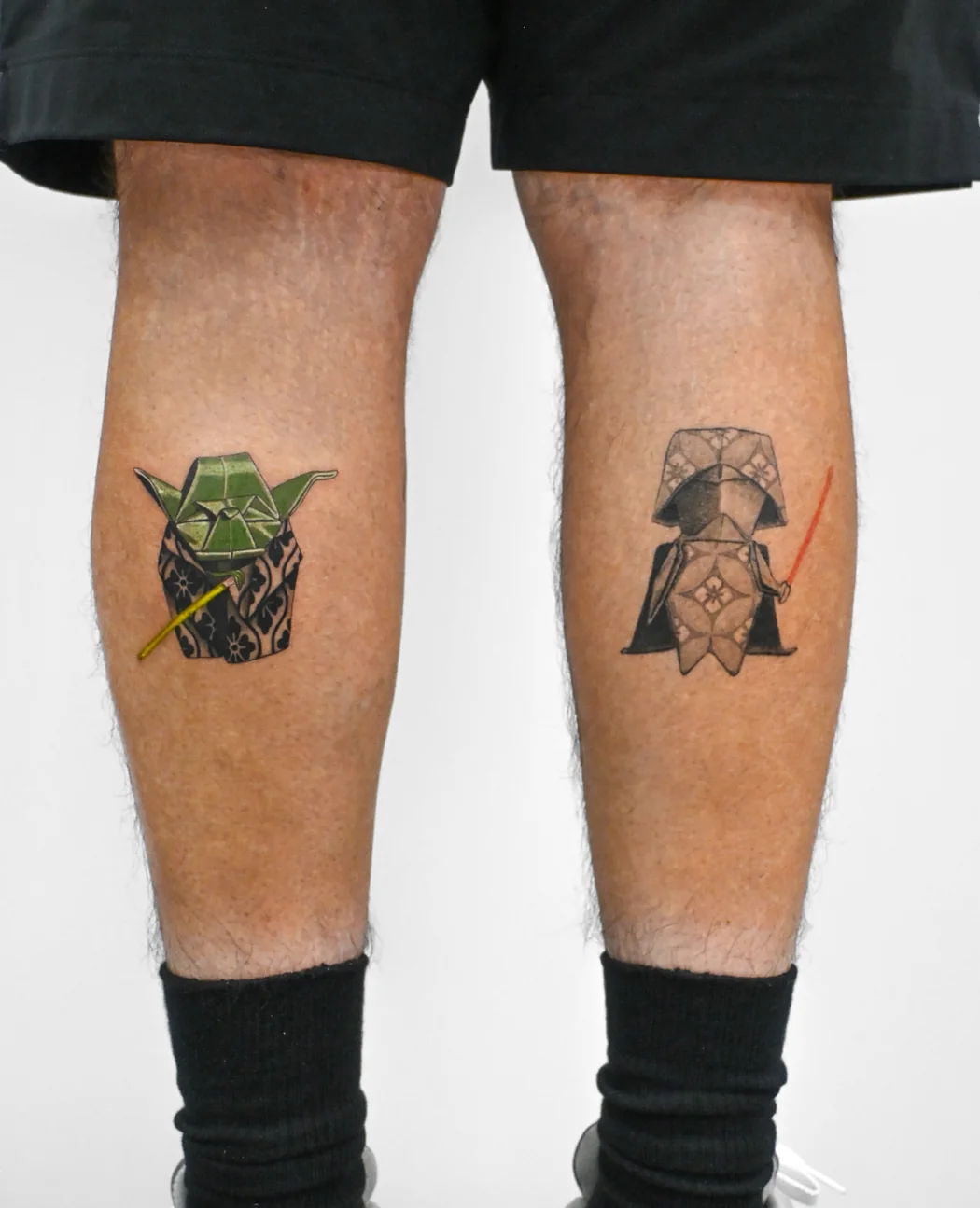 Yoda on one calf and Darth Vader on the other, in colour